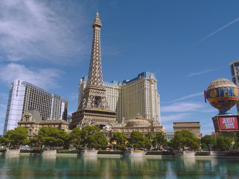 A view of the Paris Eiffel Tower and a few casinos behind in front of the Bellagio Fountains on the Las Vegas Strip.