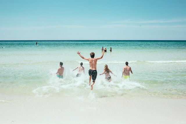 Features a group of friends running into the ocean.