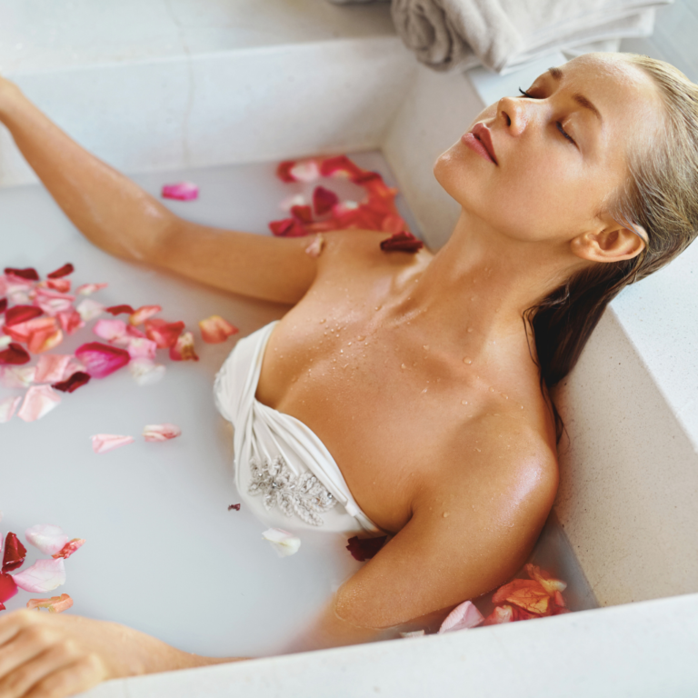 A women relaxing in a milky rose water bath. A birthday spa day at home.